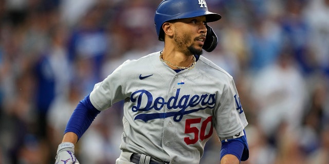 Los Angeles Dodgers' Mookie Betts watches his double off Colorado Rockies relief pitcher Mychal Givens during the seventh inning of a baseball game Saturday, July 17, 2021, in Denver.