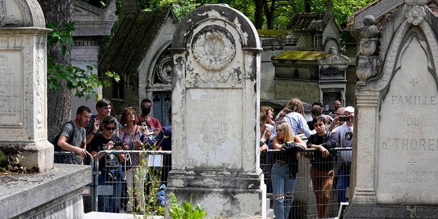 Fans will arrive at the grave of rock singer Jim Morrison at the Pere-Lachaise Cemetery in Paris on Saturday, July 3, 2021.  (Associated Press)