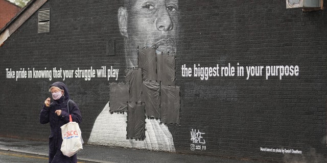 MANCHESTER, ENGLAND - JULY 12: Bin bags cover offensive graffiti on the vandalized mural of Manchester United striker and England player Marcus Rashford on the wall of a cafe in Manchester. (Photo by Christopher Furlong/Getty Images)