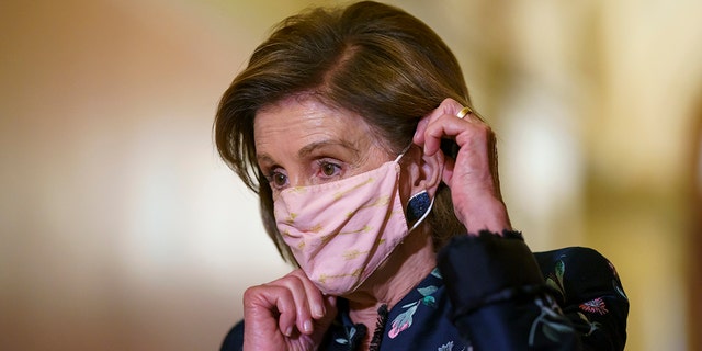 House Speaker Nancy Pelosi wears a face mask as she hosts a visit by King Abdullah II of Jordan, at the Capitol on July 22, 2021.