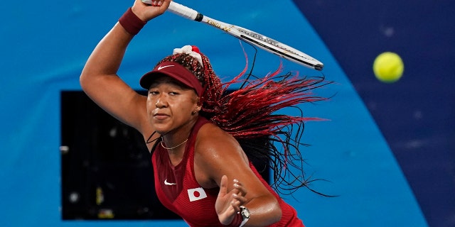 Naomi Osaka, of Japan, plays Marketa Vondrousova, of the Czech Republic, during the third round of the tennis competition at the 2020 Summer Olympics, Tuesday, July 27, 2021, in Tokyo, Japan. (AP Photo/Seth Wenig)
