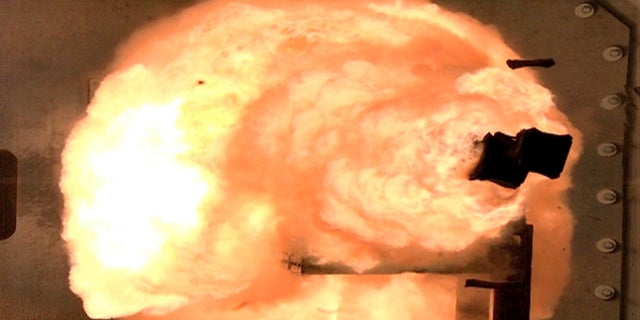 A high-speed camera image captures a full-energy shot by an electromagnetic railgun prototype launcher at a test facility in Dahlgren, Va. The Navy has pulled the plug on research on the futuristic weapon that fires projectiles at up to seven times the speed of sound using electricity. (AP/U.S. Navy)