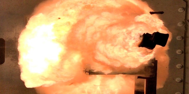 A high-speed camera image captures a full-energy shot by an electromagnetic railgun prototype launcher at a test facility in Dahlgren, Va. The Navy has pulled the plug on research on the futuristic weapon that fires projectiles at up to seven times the speed of sound using electricity. (AP/U.S. Navy)