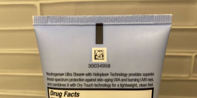 In this photo example of the Neutrogena Ultra Sheer with Helioplex Technology sunscreen, the product's lot number and expiration date are listed at the back of the lotion tube, near the top. The sunscreen will expire in October 2021. This Neutrogena product isn't listed in Johnson &amp; Johnson's current national recall.