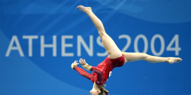 American gymnast Carly Patterson competed her way through the women's individual artistic gymnastics final in a vibrant red leotard at the Athens 2004 Summer Olympics.