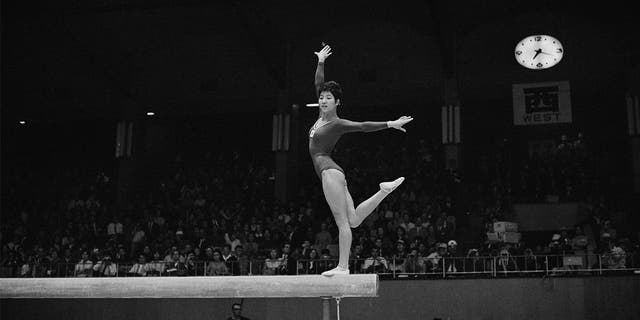 Japanese Olympic gymnast Chiba Ginko performed her routine on the balance beam during the women's artistic team all-around gymnastic competition on October 20, 1964, during the Tokyo 1964 Summer Olympics.