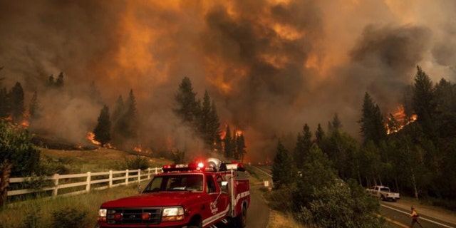 The rapidly growing wildfire jumped a highway, prompting more evacuation orders and the cancellation of an extreme bike ride through the Sierra Nevada.