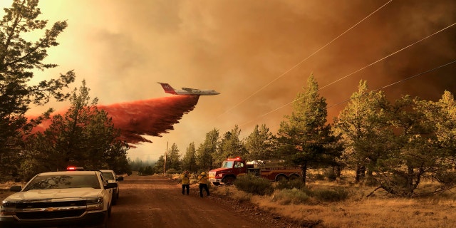 This photo provided by the Oregon Department of Forestry shows a firefighting tanker making a retardant drop over the Grandview Fire near Sisters, Ore., Sunday, July 11, 2021. (Oregon Department of Forestry via AP)