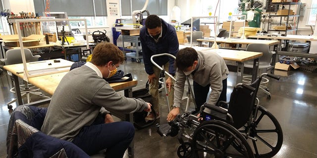 Students at Bullis School in Potomac, Maryland, working on the wheelchair stroller. 