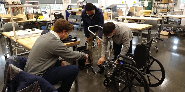 Students at Bullis School in Potomac, Maryland, working on the wheelchair stroller. 