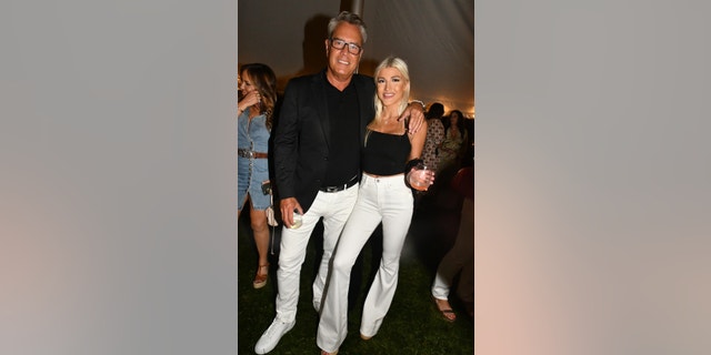 Peter Cook poses happily with his fiancée Alba Jancou at a 4th of July party in Southampton. The 62-year-old posed for cameras in matching black and white with his 21-year-old love. The couple got engaged two years ago in Greece, although it seems as if they have yet to get married.
