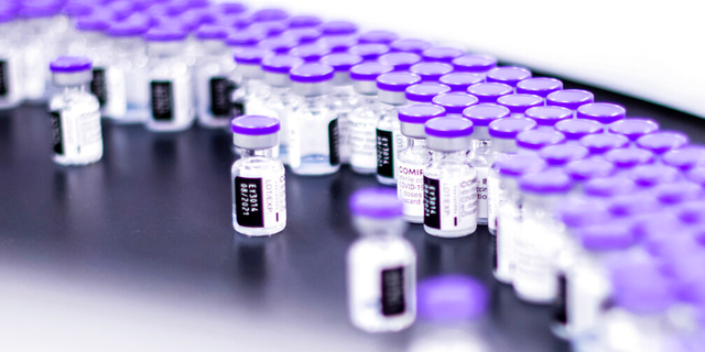 In this March 2021 photo provided by Pfizer, vials of the Pfizer-BioNTech COVID-19 vaccine are being prepared for packaging at the company's facilities in Puurs, Belgium. 