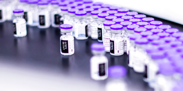 In this March 2021 photo provided by Pfizer, vials of the Pfizer-BioNTech COVID-19 vaccine are prepared for packaging at the company’s facility in Puurs, Belgium. 