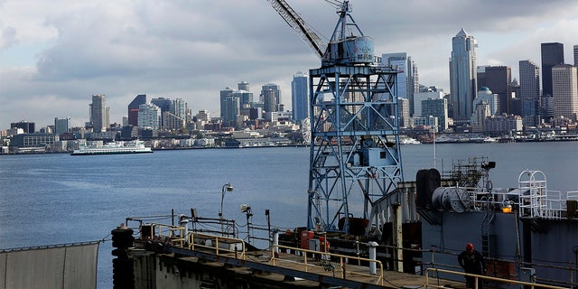 A Washington State Ferry traverses past the city skyline through Puget Sound as seen from the Vigor Shipyard in Seattle, Washington, U.S., on Friday, April 18, 2014. 