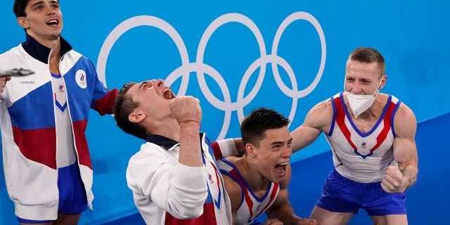 Russian Olympic Committee's artistic gymnastics men's team, from right, Denis Abliazin, right, Nikita Nagornyy, David Belyavskiy and Artur Dalaloyan celebrate after winning the gold medal at the 2020 Summer Olympics, Monday, July 26, 2021, in Tokyo. (AP Photo/Gregory Bull)