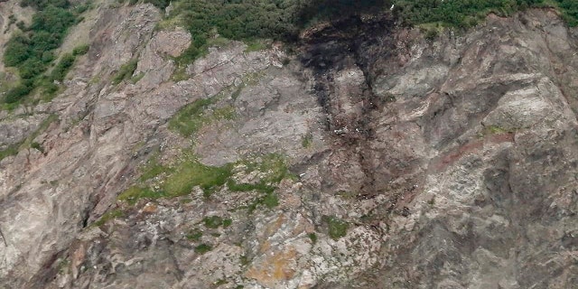 This photo released by the Russia Emergency Situations Ministry press service on Wednesday, July 7, 2021, shows wreckage of a missing Antonov An-26 missing plane found near its destination airport outside the town of Palana, in Russia's Far East. The plane carrying 28 people crashed Tuesday, apparently as it came in for a landing in bad weather in Russia’s Far East, and everyone aboard was feared dead. (Russia Emergency Situations Ministry press service via AP)