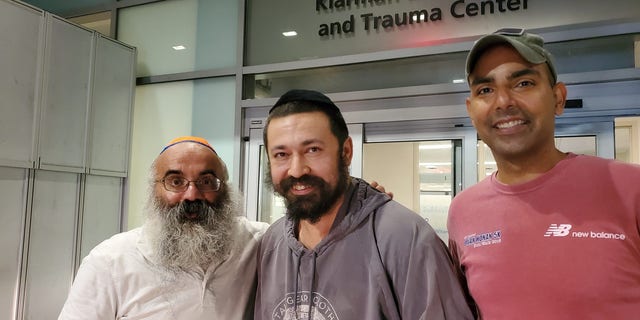 Rabbi Shlomo Noginski, center, was discharged from hospital on Thursday after being stabbed several times in the arm earlier in the day. 