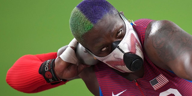 Raven Saunders, of the United States, competes in the qualification rounds of the women's shot put at the 2020 Summer Olympics, Friday, July 30, 2021, in Tokyo.