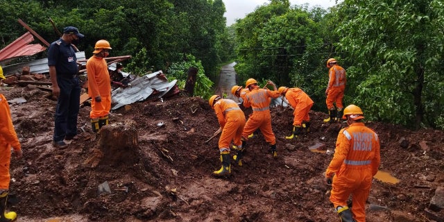 Members of National Disaster Response Force (NDRF) conduct a search and rescue operation after a landslide following heavy rains in Ratnagiri district, Maharashtra state, India, July 25, 2021. National Disaster Response Force/Handout via REUTERS