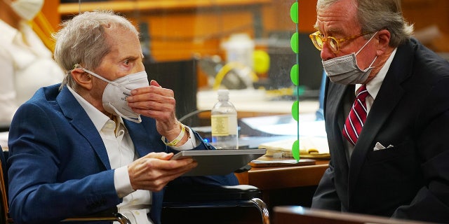 Defendant Robert Durst is assisted by his attorney Dick DeGuerin in an Inglewood courtroom as Judge Mark E. Windham (not shown) gives instructions before opening statements in the trial of the real estate scion charged with murder of longtime friend Susan Berman, in Inglewood, Calif, May 18, 2021. (Al Seib/Pool via REUTERS)