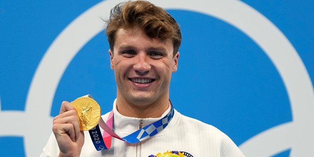 Robert Finke of the United States poses with his gold medal for the men's 800-meters freestyle final at the 2020 Summer Olympics, Thursday, July 29, 2021, in Tokyo. (Associated Press)