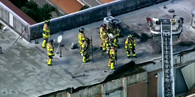 Firefighters on the roof of an apartment building in northwest Miami-Dade collapsed Thursday.