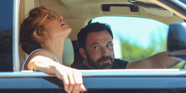 Ben Affleck adoringly stares at Jennifer Lopez while the two are stuck in Los Angeles traffic.