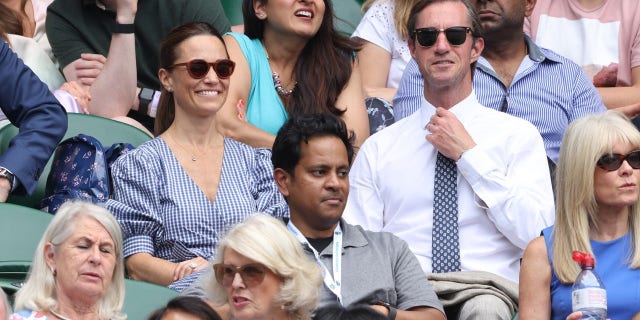 Pippa Middleton and her husband James Matthews look on from the stand on day 11 of The Championships at Wimbledon.