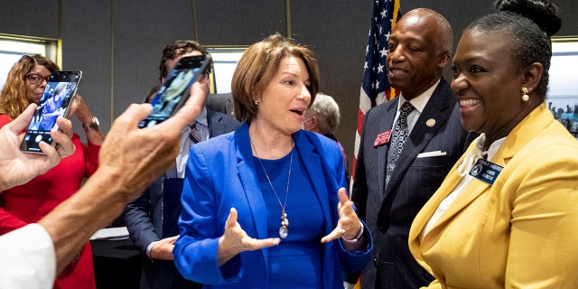 Sen. Amy Klobuchar, center, D-Minn., talks with Georgia State Legislators following a Senate Rules Committee field hearing on voting rights at the National Center for Civil and Human Rights in Atlanta, Monday, July 19, 2021. (AP Photo/Ben Gray)