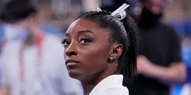 Simone Biles, of the United States, waits for her turn to perform during the artistic gymnastics women's final at the 2020 Summer Olympics, Tuesday, July 27, 2021, in Tokyo.