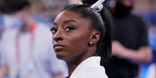 Simone Biles, of the United States, waits for her turn to perform during the artistic gymnastics women's final at the 2020 Summer Olympics, Tuesday, July 27, 2021, in Tokyo.