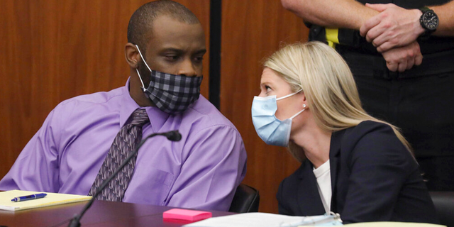 Defendant Nathaniel Rowland chats with his lawyer Alicia Goode, right, during his trial in Richland County Court Tuesday July 20, 2021 in Columbia, SC 