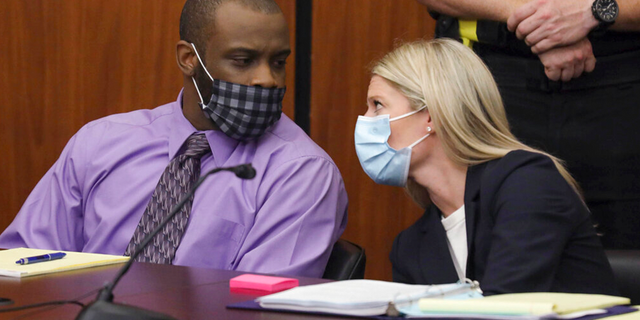 Defendant Nathaniel Rowland speaks with his attorney, Alicia Goode, right, during his trial in Richland County Court, Tuesday, July 20, 2021, in Columbia, S.C.