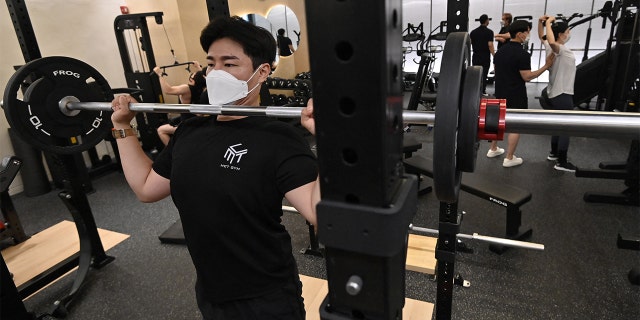 People exercise at a gym in Seoul on July 13, 2021, as South Korea announced implementation of level 4 social distancing measures amid concerns of a fourth wave of the coronavirus pandemic. 