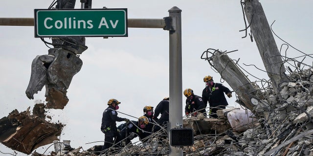 Members of a Pennsylvania search-and-rescue team will clear the remains of the Champlain Tower South complex on Monday. (AP / Miami Herald)