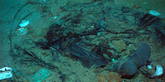 This 2004 photo provided by the Institute for Exploration, Center for Archaeological Oceanography/University of Rhode Island/NOAA Office of Ocean Exploration, shows the remains of a coat and boots in the mud on the sea bed near the Titanic's stern. (Institute for Exploration, Center for Archaeological Oceanography/University of Rhode Island/NOAA Office of Ocean Exploration)