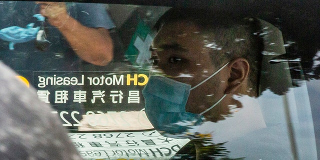 Tong Ying-kit, who is accused of deliberately driving his motorcycle into a group of police officers on July 1, arrives at the West Kowloon court in Hong Kong on July 6, 2020. - Tong, 23, charged with inciting secession and one charge of terrorism, became the first person in Hong Kong on July 3 to be charged under Beijing's sweeping new national security law. (Photo by ISAAC LAWRENCE / AFP) (Photo by ISAAC LAWRENCE/AFP via Getty Images)