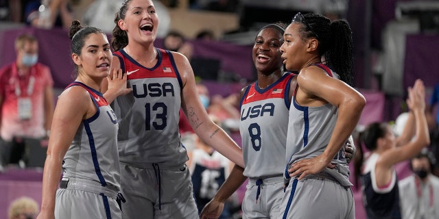 US players Kelsey Plum, left, Stefanie Dolson (13), Jacquelyn Young (8) and Allisha Gray celebrate after beating the Russian Olympic Committee in a 3-on-3 women's basketball match at the Olympic Games in summer of 2020, Wednesday, July 28, 2021, in Tokyo.  (Associated press)