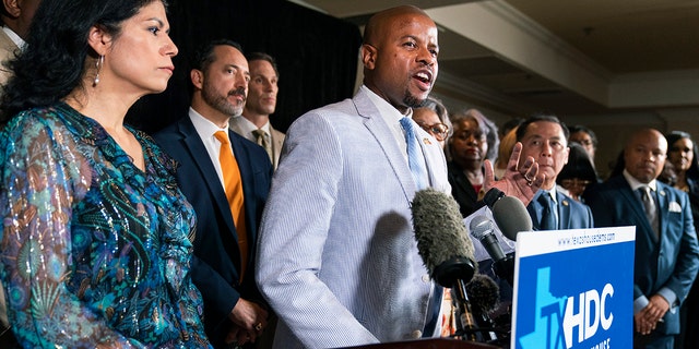 Texas Democratic Representative Ron Reynolds of Missouri City, center, with other Texas lawmakers speaks at a press conference Wednesday, July 14, 2021, in Washington. 