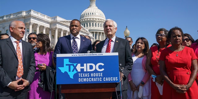 Rep. Marc Veasey, D-Texas, center left, and Rep. Lloyd Doggett, D-Texas, joined at left by Rep. Chris Turner, chairman of the Texas House Democratic Caucus, welcome Democratic members of the Texas legislature at a news conference at the Capitol in Washington, Tuesday, July 13, 2021.