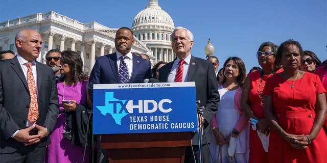 Rep. Marc Veasey, D-Texas, center left, and Rep. Lloyd Doggett, D-Texas, joined at left by Rep. Chris Turner, chairman of the Texas House Democratic Caucus, welcome Democratic members of the Texas legislature at a news conference at the Capitol in Washington, Tuesday, July 13, 2021.