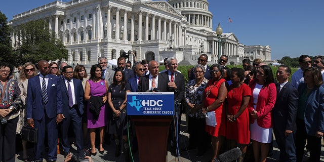 WASHINGTON, DC - JULY 13: Flanked by other state House Democrats, Texas State Rep. Chris Turner (D-District 101) (C), Chair of the Texas House Democratic Caucus, speaks during a news conference on voting rights outside the U.S. Capitol July 13, 2021 in Washington, D.C. (Photo by Alex Wong/Getty Images)
