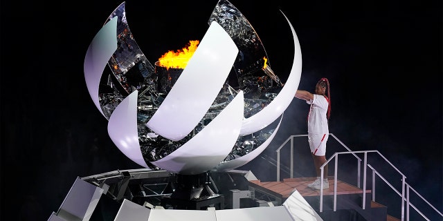 Japan's Naomi Osaka lights the cauldron during the opening ceremony in the Olympic Stadium at the 2020 Summer Olympics, Friday, July 23, 2021, in Tokyo, Japan. (AP Photo/Patrick Semansky)