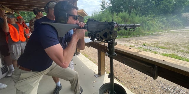 Republican Sen. Tom Cotton of Arkansas fires a machine gun at the third annual Hillsborough County, New Hampshire GOP machine gun shoot event and fundraiser, on July 17, 2021.