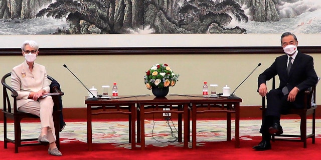In this photo provided by the U.S. Department of State, U.S. Deputy Secretary of State Wendy Sherman, left, and Chinese Foreign Minister Wang Yi sit together in Tianjin, China, Monday, July 26, 2021. (U.S. Department of State via AP)