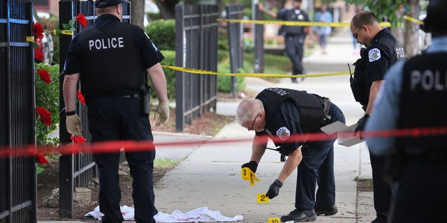 Police investigate a crime scene where three people were shot at the Wentworth Gardens housing complex in the Bridgeport neighborhood on June 23, 2021 in Chicago, Illinois. (Scott Olson/Getty Images)