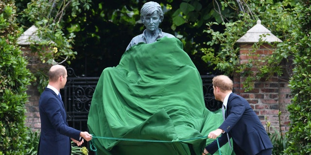 Britain's Prince William, left and Prince Harry unveil a statue they commissioned of their mother, Princess Diana, on what woud have been her 60th birthday, in the Sunken Garden at Kensington Palace, London, Thursday July 1, 2021.