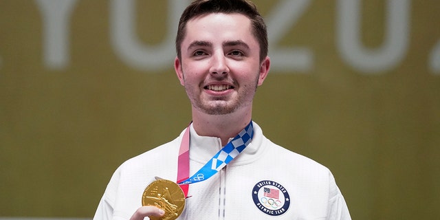 William Shaner of the United States holds his gold medal after the men's 10-meter air rifle at the Asaka Shooting Range at the 2020 Summer Olympics on Sunday, July 25, 2021, in Tokyo.  (Associated press)