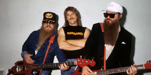 Dusty Hill, Frank Beard and Billy Gibbons - posed, group shot, backstage at Monsters Of Rock, Hot Rod shaped guitars, novelty guitars.