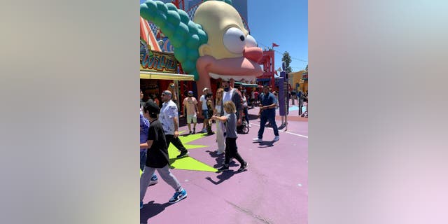 The Hollywood actors were accompanied by bodyguards while they explored the Los Angeles theme park, according to SWNS. Lopez and Affleck reportedly took their kids to the park's Simpsons Ride. (Credit: SWNS)